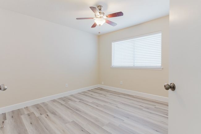 Spare room featuring ceiling fan, light wood-style flooring, and baseboards | Image 17