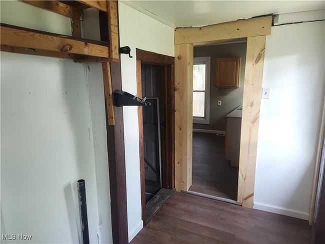 Hall with dark wood-type flooring and baseboards | Image 27