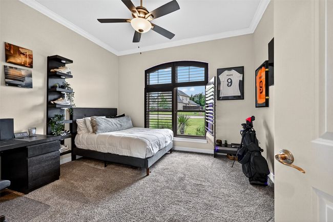 Bedroom featuring carpet, ornamental molding, and ceiling fan | Image 31