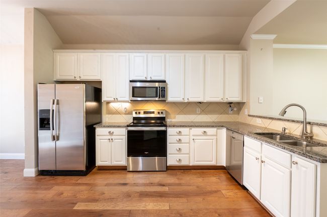 Granite countertops & stainless steel appliances. Refrigerator will convey. | Image 6
