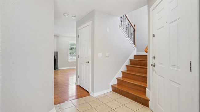 Stairway with baseboards and tile patterned floors | Image 14