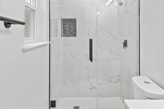 Full bathroom featuring a stall shower and toilet | Image 15