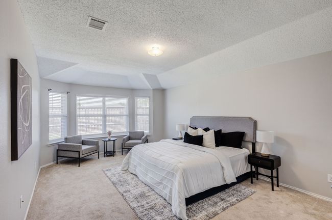 Bedroom with carpet floors, a textured ceiling, and baseboards | Image 24