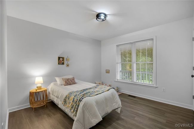 Bedroom with wood finished floors and baseboards | Image 18