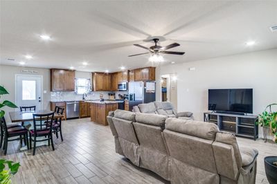 Living room featuring a textured ceiling, sink, ceiling fan, and light hardwood / wood-style floors | Image 3