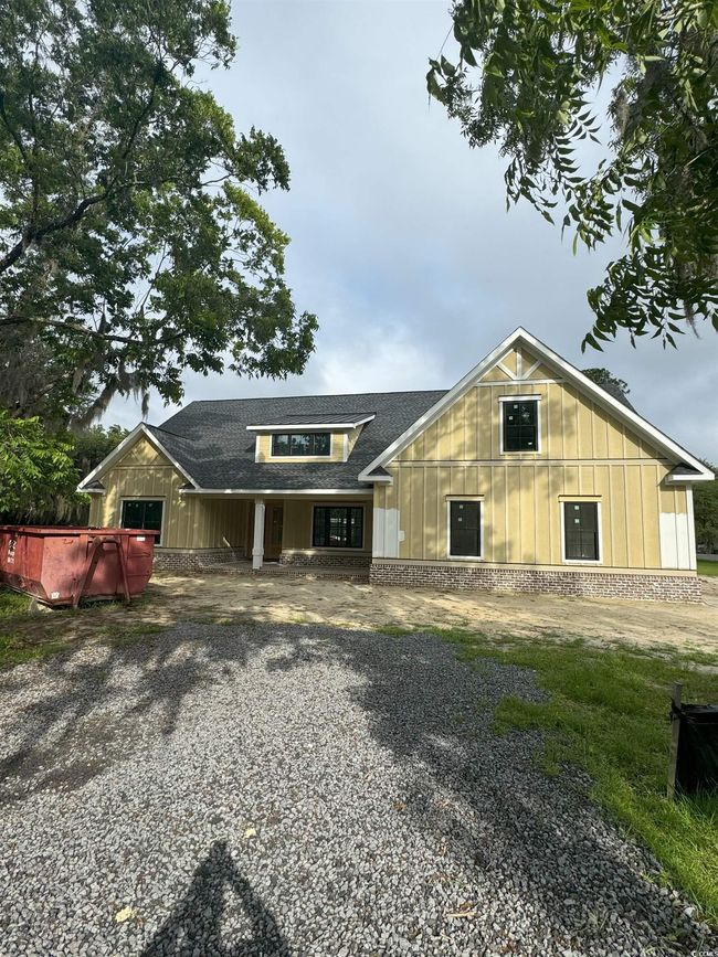 View of front of property with roof with shingles and board and batten siding | Image 4