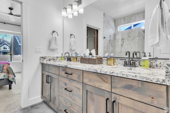 Full bathroom with double vanity and a stall shower | Image 21