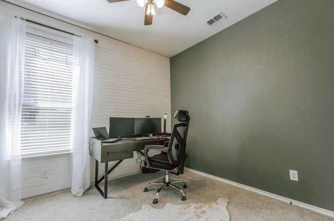 Office space with carpet flooring, visible vents, ceiling fan, and baseboards | Image 11