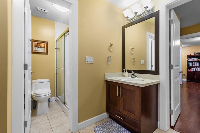 Full bath featuring toilet, a stall shower, baseboards, and vanity | Image 36