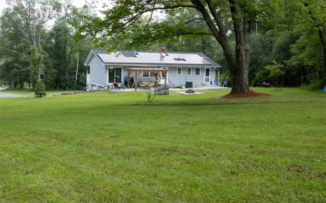 Rear view of property with a fire pit, a patio, and a lawn | Image 6