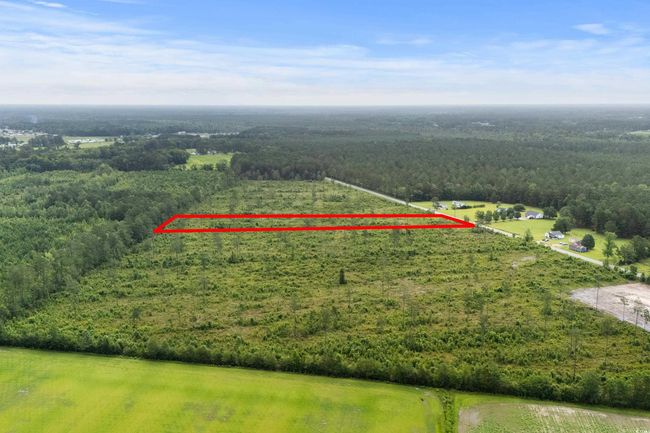 View of property location featuring a heavily wooded area and property parcel outlined | Image 12