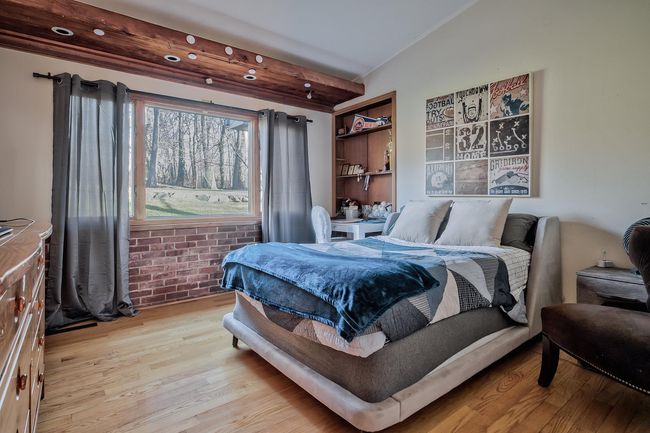 Bedroom with lofted ceiling and light wood-style floors | Image 11