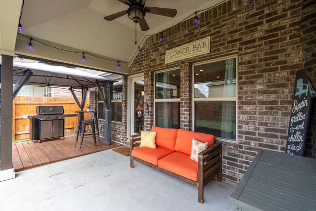 View of patio / terrace with a gazebo, a ceiling fan, outdoor lounge area, fence, and a grill | Image 28
