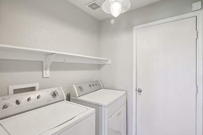 Laundry room featuring washer and dryer, laundry area, and visible vents | Image 21