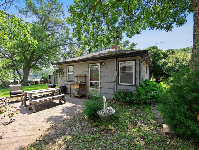 A beautifully maintained guest house sits on the property, ideal for hosting visitors or potential rental income. Just outside the guest house, enjoy a 15' x 12' concrete patio with peaceful lake views—an ideal spot for morning coffee. | Image 17