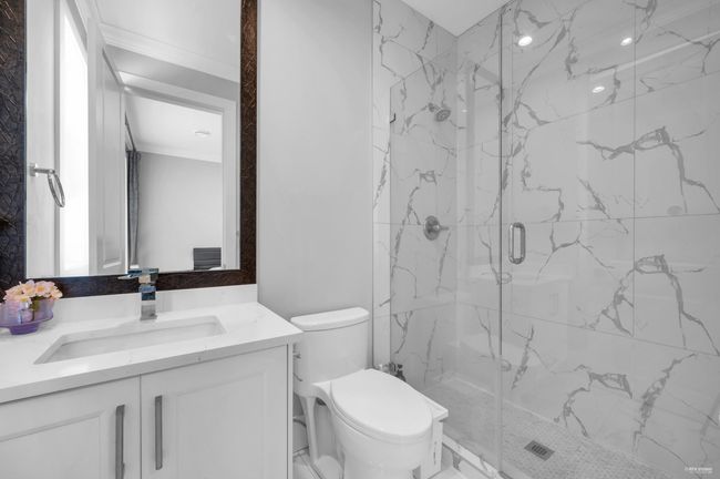 Bathroom with a marble finish shower and vanity | Image 33