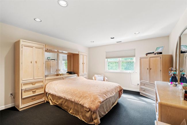 Bedroom with dark colored carpet, recessed lighting, and baseboards | Image 17