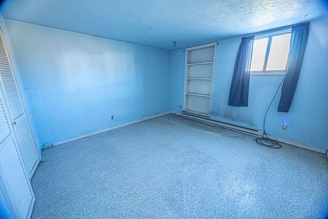 Unfurnished bedroom featuring a textured ceiling | Image 34