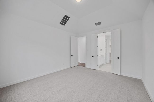 Unfurnished bedroom with light carpet and baseboards | Image 11