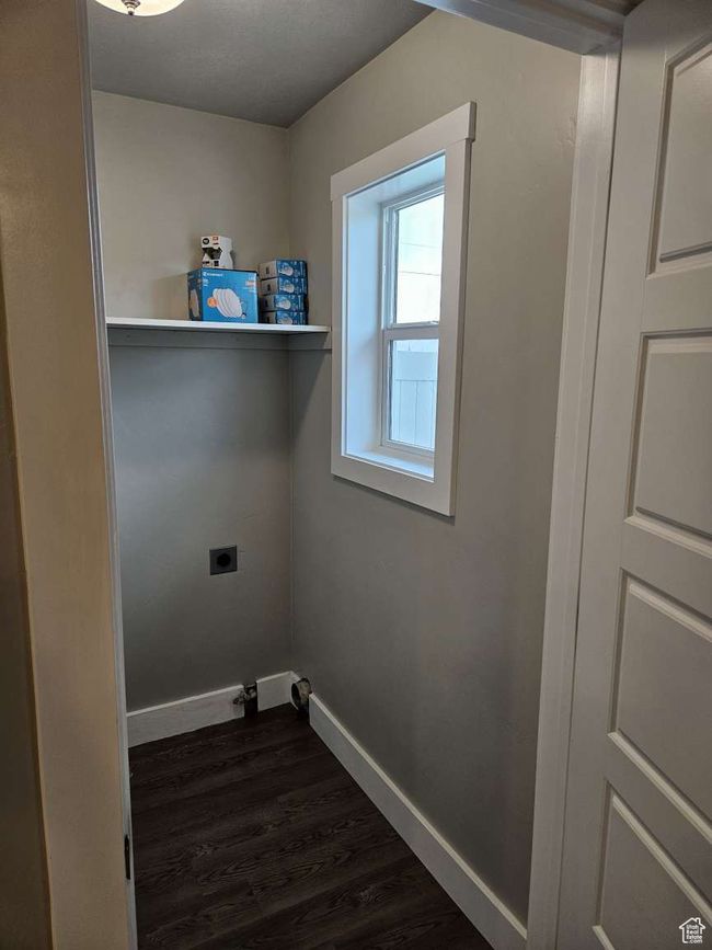 Washroom with hookup for an electric dryer, dark wood-style flooring, laundry area, and baseboards | Image 8