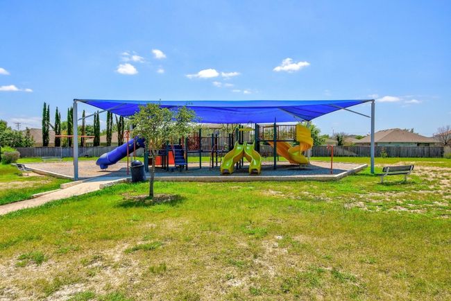 Community play area featuring fence and a lawn | Image 37
