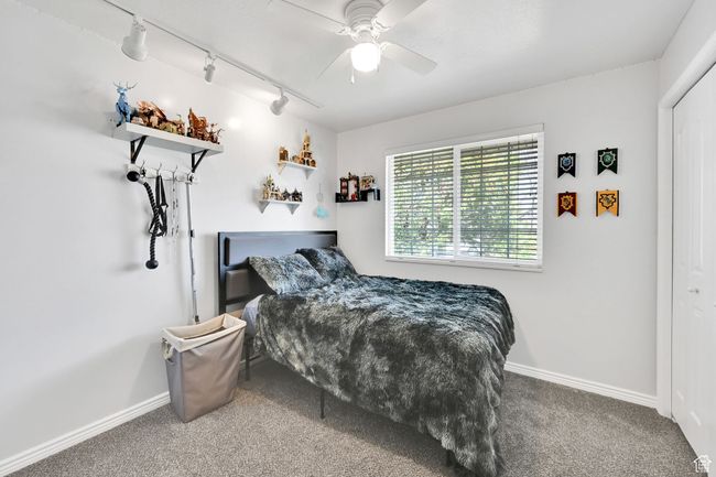 Bedroom featuring carpet flooring, a ceiling fan, and baseboards | Image 23