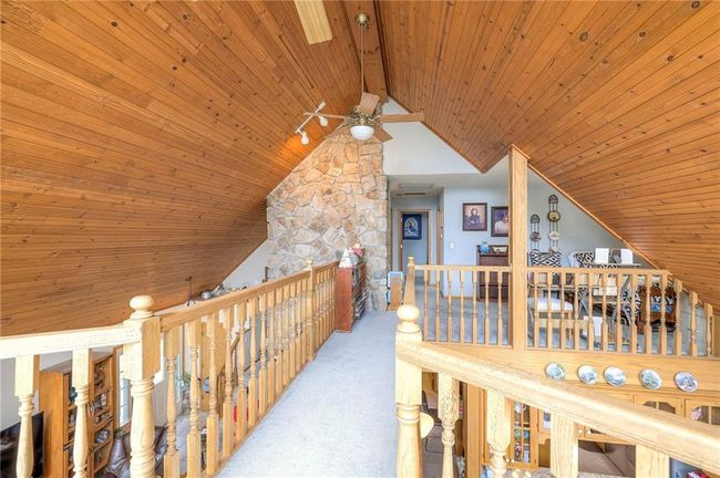Corridor featuring wood ceiling, an upstairs landing, lofted ceiling, and carpet floors | Image 25