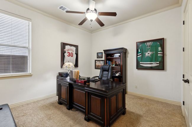 Office area featuring baseboards, visible vents, light colored carpet, and ceiling fan | Image 18