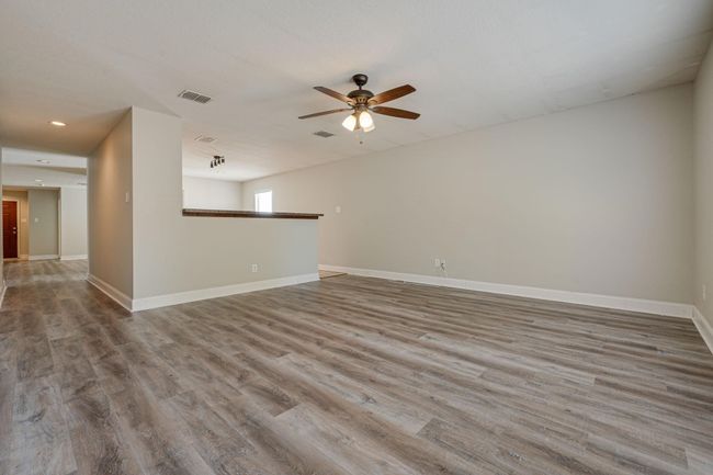 Spare room with ceiling fan, wood finished floors, and recessed lighting | Image 13