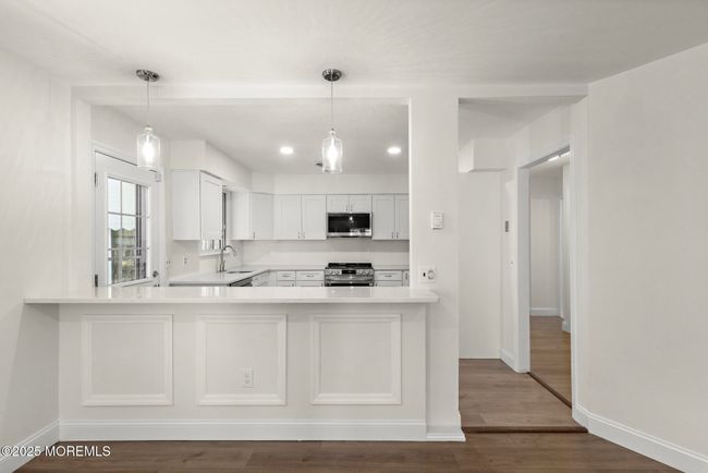 Breakfast bar with quartz countertops and shadow boxes | Image 9
