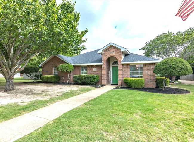 View of front of home with roof with shingles and brick siding | Image 39