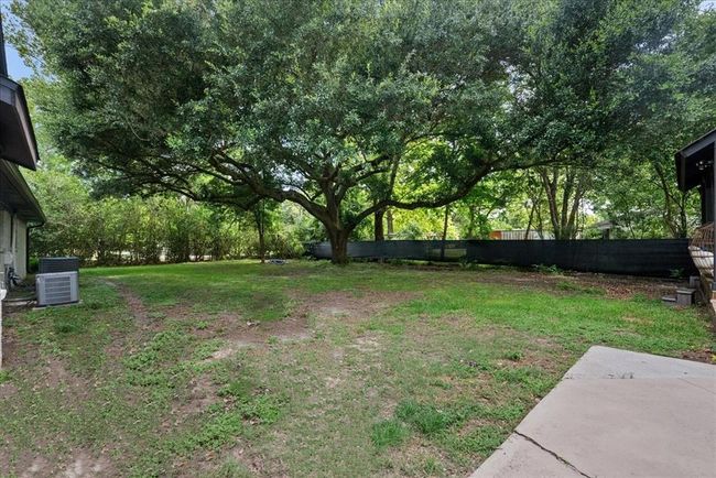 Peaceful yard anchored by a stunning, mature oak tree—ideal for lounging or play. | Image 39