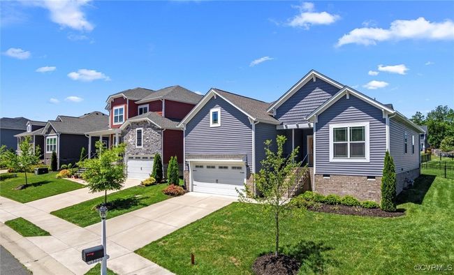 Craftsman inspired home with driveway, an attached garage, a front yard, and crawl space | Image 6