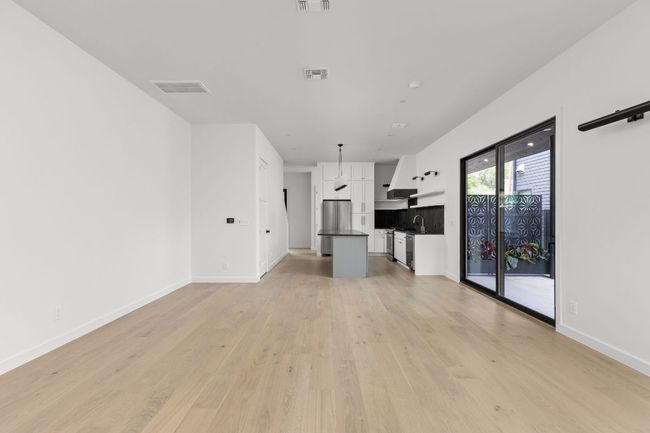Unfurnished living room with light wood finished floors and baseboards | Image 17