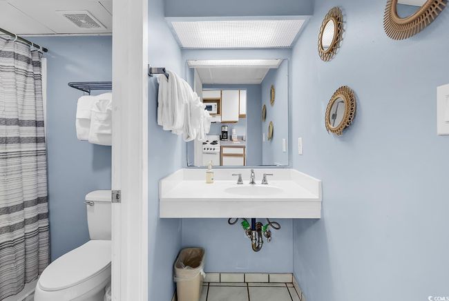 Full bathroom with tile patterned floors and a shower with shower curtain | Image 12