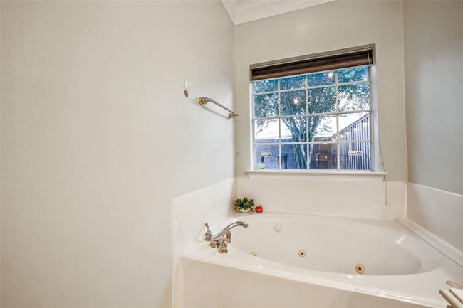 Primary bathroom with jetted tub, shower, double sink vanity and spacious closet. | Image 18