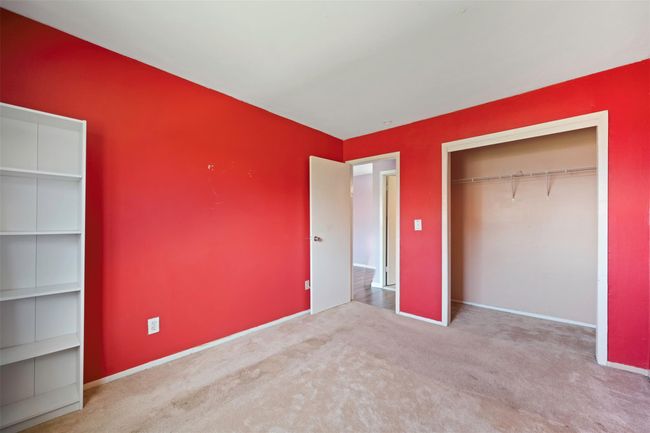 Unfurnished bedroom with baseboards, carpet, and a closet | Image 14