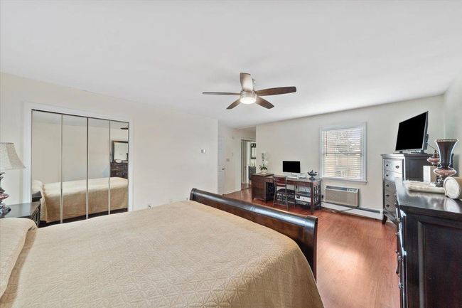 Bedroom featuring a closet, ceiling fan, and wood finished floors | Image 17