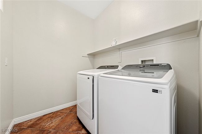 Laundry room featuring independent washer and dryer and baseboards | Image 24
