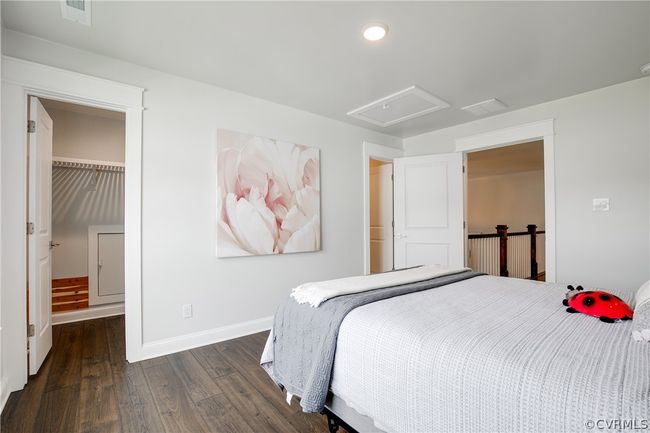 Bedroom featuring dark wood-type flooring, a spacious closet, and a closet | Image 31