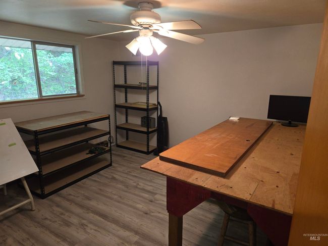 Home office with a ceiling fan and wood finished floors | Image 14