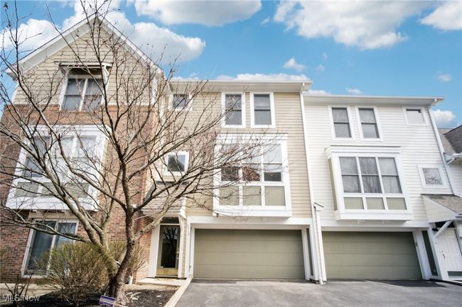View of property featuring driveway and an attached garage | Image 38