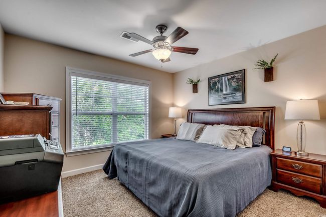 Bedroom with multiple windows and a ceiling fan | Image 23