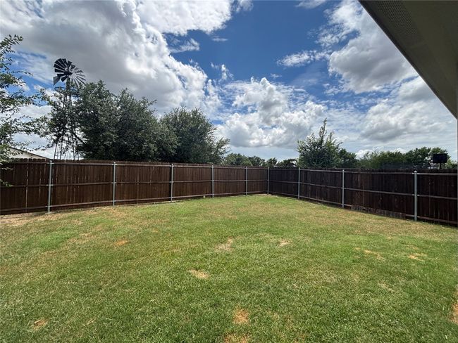 View of fenced backyard | Image 14