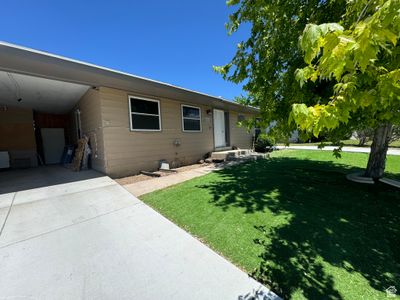 Rear view of house with a carport and a yard | Image 2