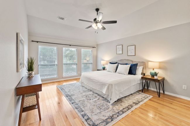 Bedroom featuring vaulted ceiling, light wood finished floors, and a ceiling fan | Image 24
