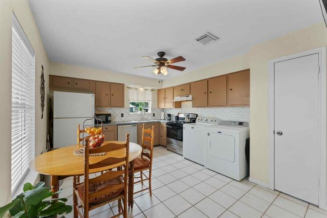 Another view of the spacious kitchen showcasing its clean layout, generous counter space, and warm, welcoming vibe—perfect for everyday living. | Image 14