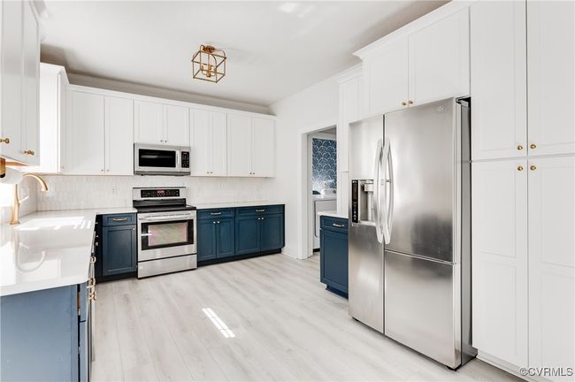 Kitchen with view to laundry/mud room and garage | Image 19