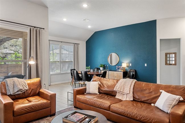 Living area featuring vaulted ceiling, wood finished floors, and recessed lighting | Image 10