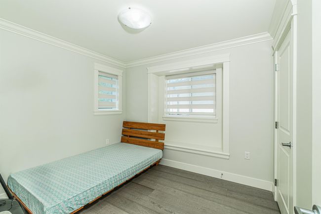 Bedroom with ornamental molding, wood finished floors, and baseboards | Image 15